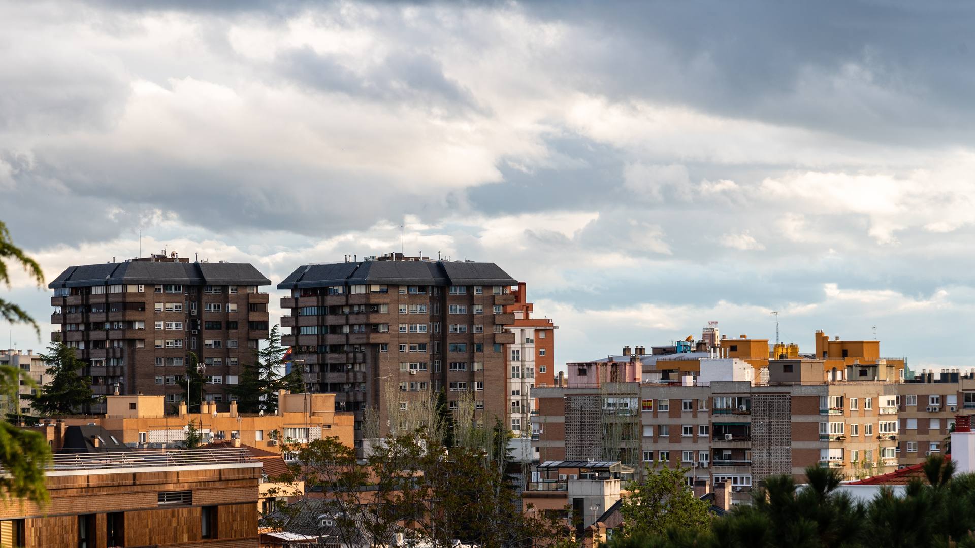 Torres y bloques de pisos de ladrillo de un barrio residencial bajo un cielo de nubes